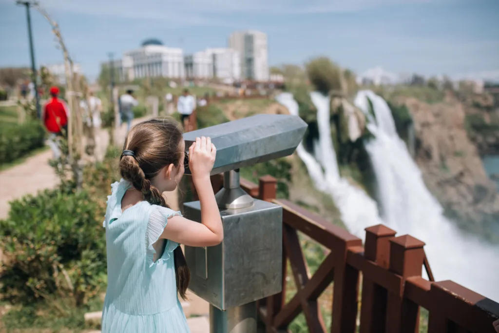 A girl tourist looking at the Duden waterfall in Antalya