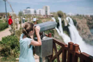 A girl tourist looking at the Duden waterfall in Antalya